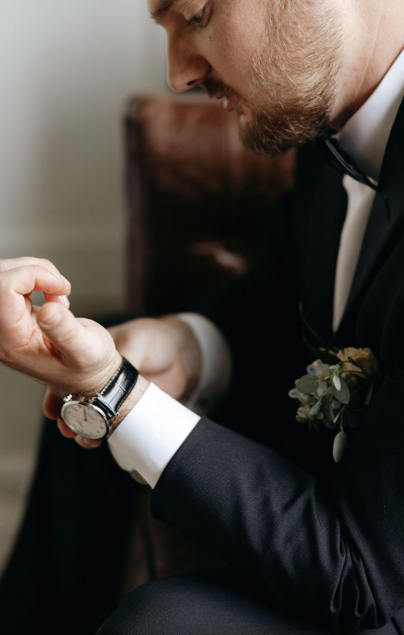 Groom trying on watch for wedding at Koury Farms